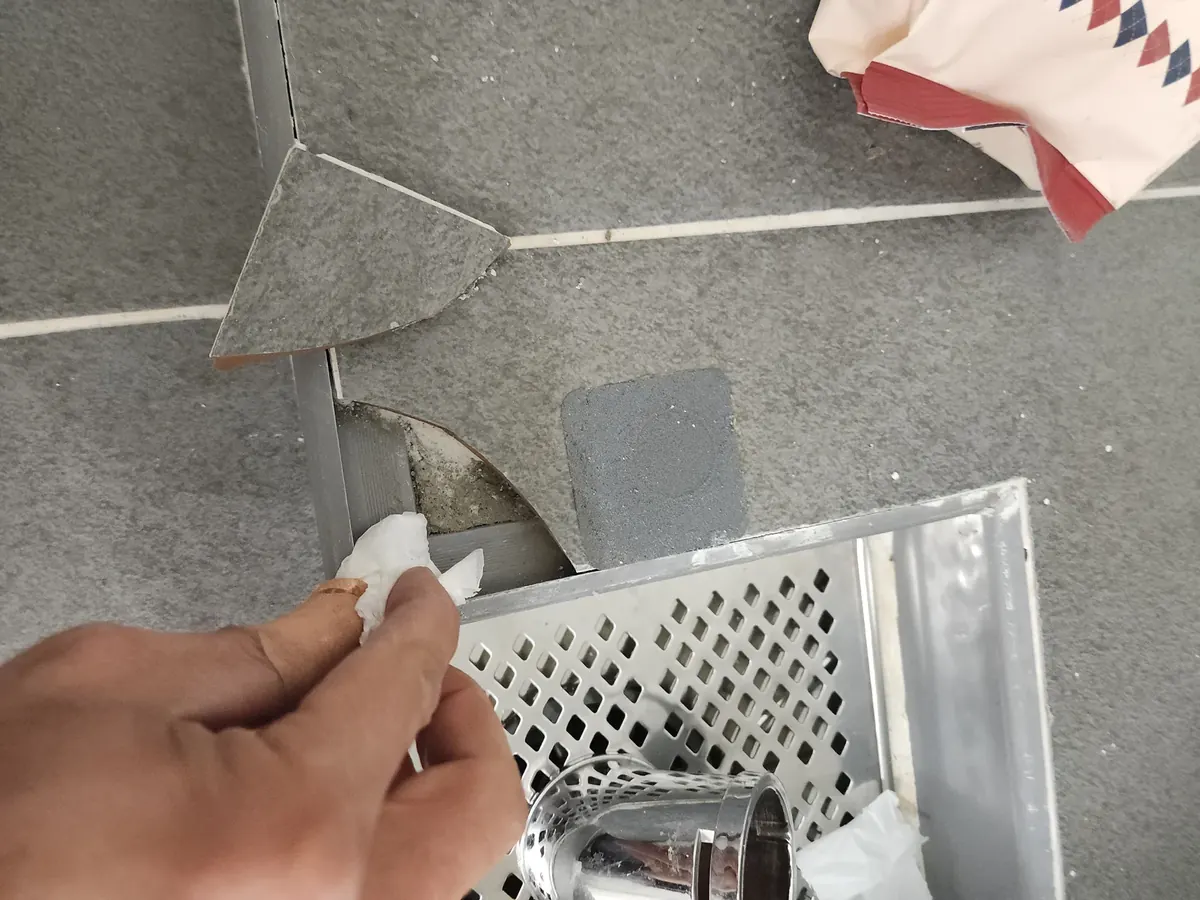 세탁실 타일 깨짐 보수 — 조각 자리를 닦는 손